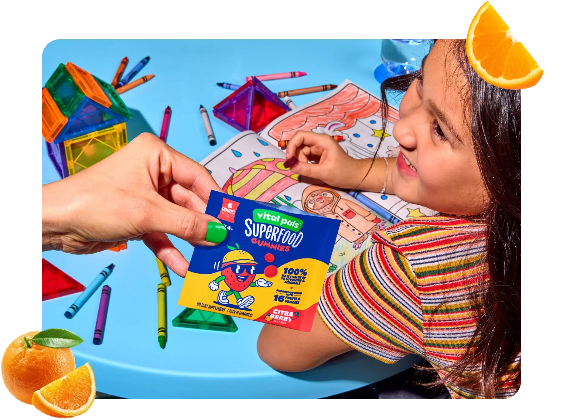 Child coloring and being handed a Vital Pals gummy pack